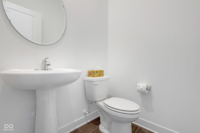 bathroom featuring wood-type flooring and toilet