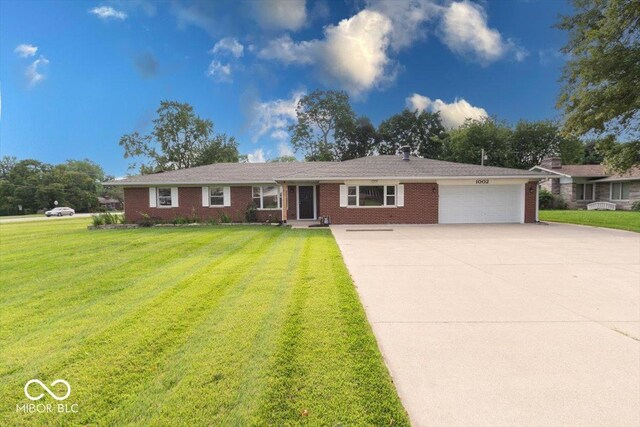 ranch-style house with a garage and a front yard