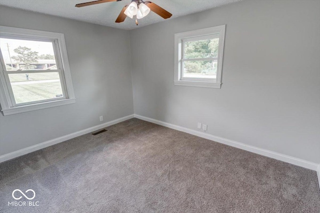 carpeted spare room featuring ceiling fan