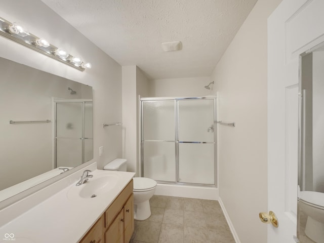 bathroom with tile patterned floors, toilet, an enclosed shower, and a textured ceiling