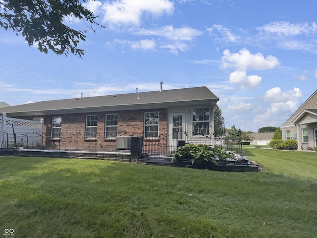 rear view of property featuring a yard