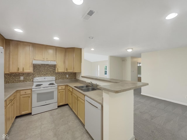 kitchen with light brown cabinetry, sink, tasteful backsplash, kitchen peninsula, and white appliances