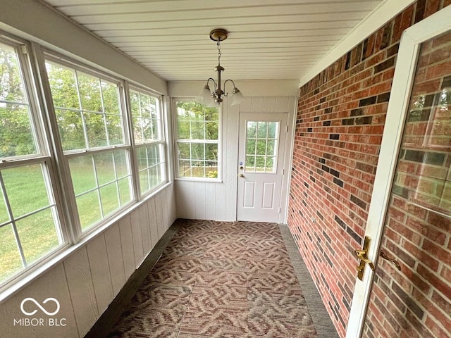 unfurnished sunroom with a chandelier