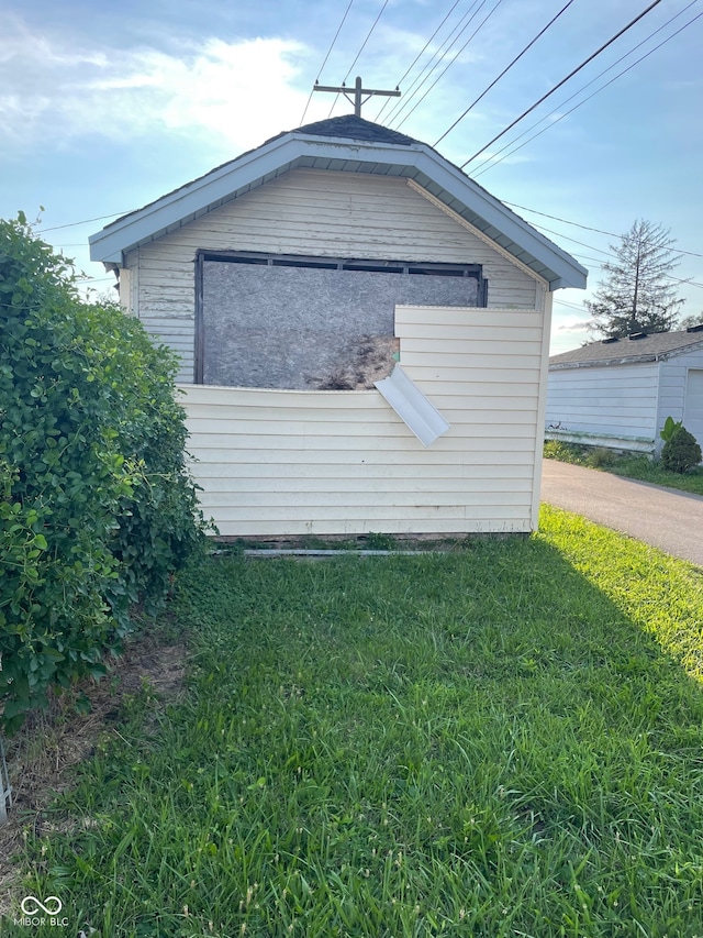 view of side of home with a yard