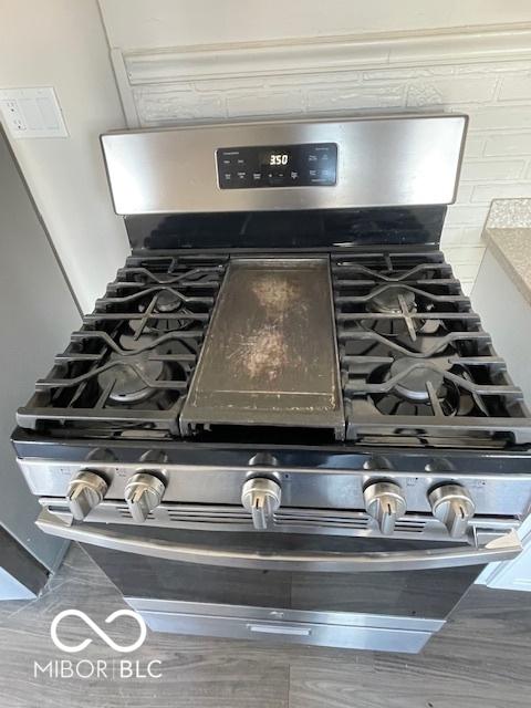 interior details with stainless steel range with gas cooktop