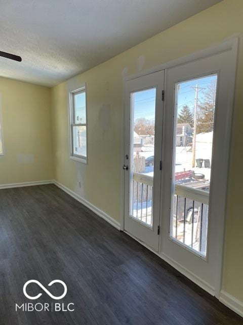 doorway featuring dark hardwood / wood-style floors and ceiling fan