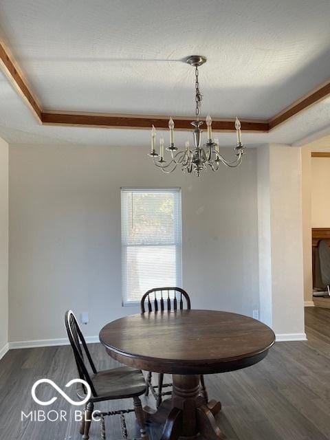 dining area featuring a chandelier, a tray ceiling, and dark hardwood / wood-style floors