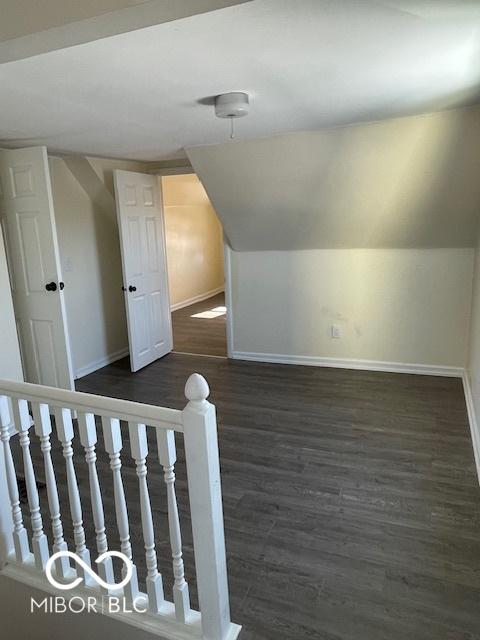 bonus room featuring dark hardwood / wood-style flooring and vaulted ceiling