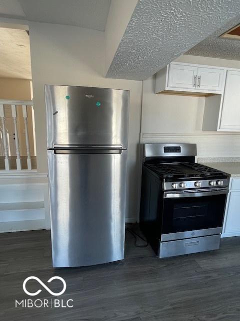 kitchen featuring white cabinets, dark hardwood / wood-style floors, and appliances with stainless steel finishes