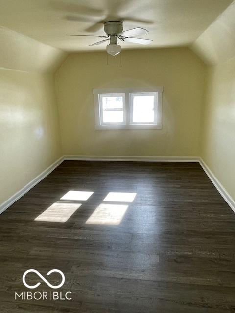 additional living space with vaulted ceiling, ceiling fan, and dark wood-type flooring