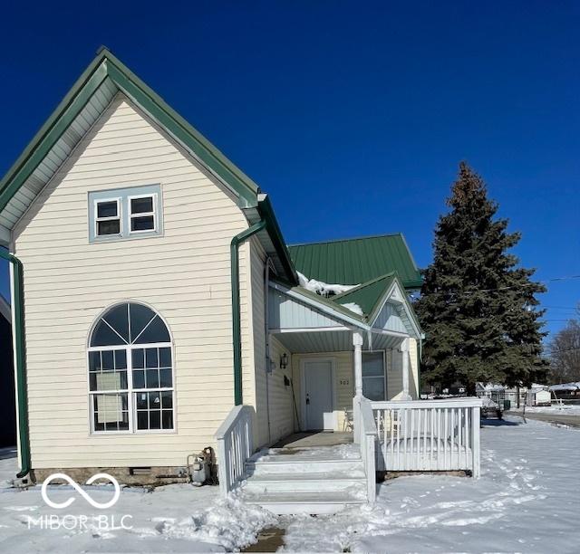 view of snowy exterior with covered porch