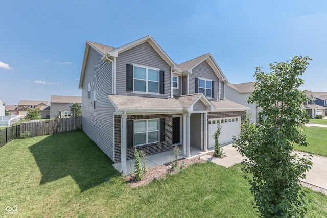 view of front of property featuring a garage and a front lawn