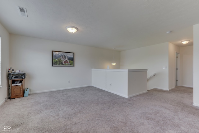 spare room with light colored carpet