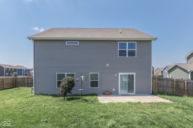 back of house with a patio and a lawn