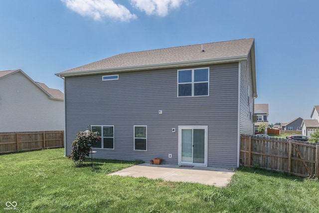 back of house with a patio area and a lawn