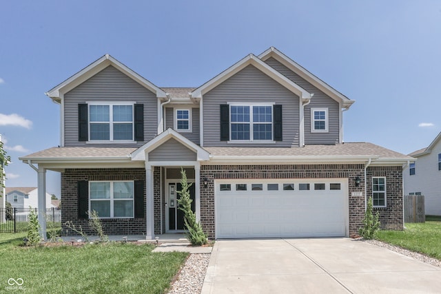 view of front of property with a garage and a front lawn