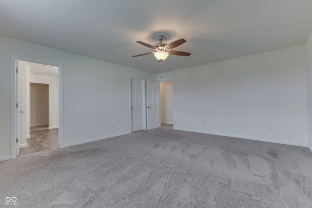 unfurnished room featuring ceiling fan and light colored carpet