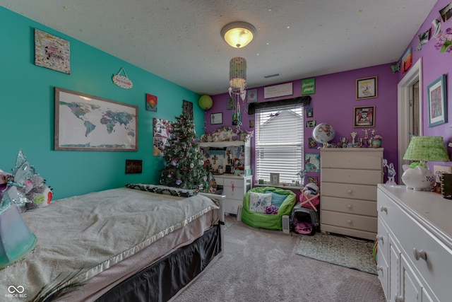 carpeted bedroom with a textured ceiling