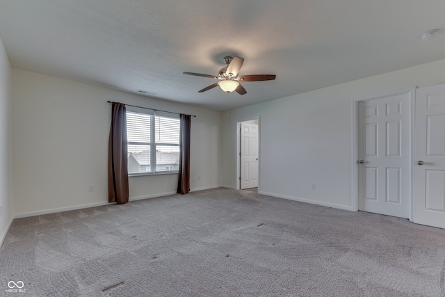 carpeted empty room with a textured ceiling and ceiling fan