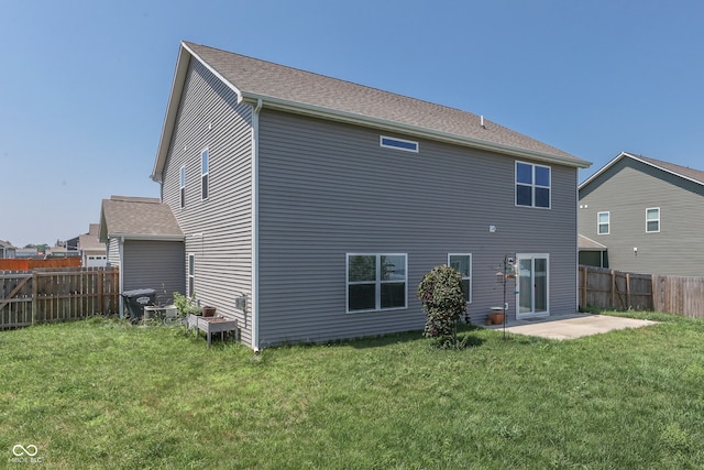 back of property with a patio and a lawn