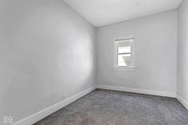 carpeted empty room with baseboards