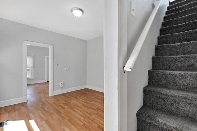stairs with baseboards and wood finished floors