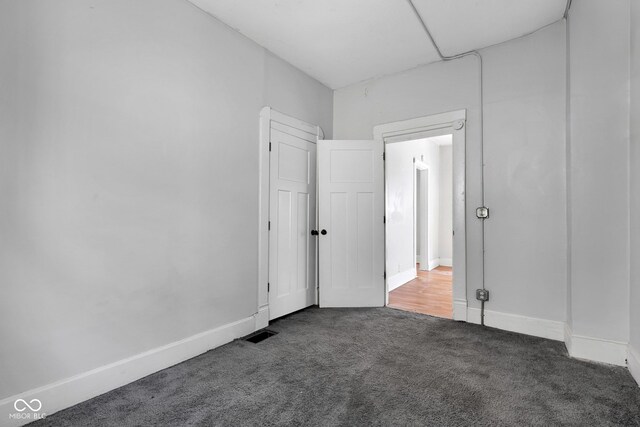 unfurnished bedroom with visible vents, baseboards, and carpet
