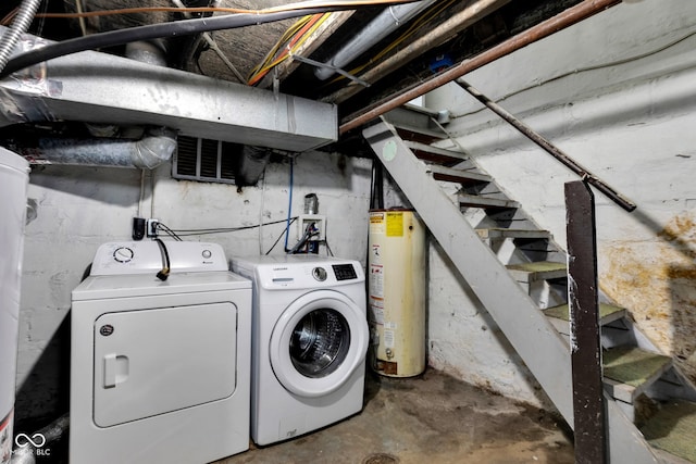 unfinished below grade area featuring independent washer and dryer, stairway, and water heater