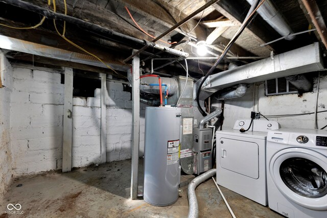 unfinished below grade area featuring water heater, heating unit, and separate washer and dryer