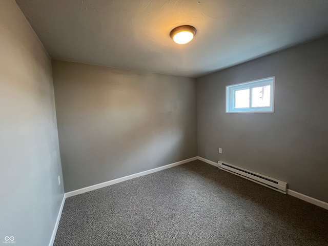 carpeted empty room featuring a baseboard radiator