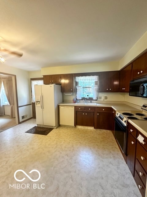 kitchen featuring ceiling fan, white appliances, and sink