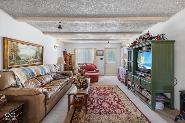 living room featuring beam ceiling, light tile patterned floors, and a textured ceiling