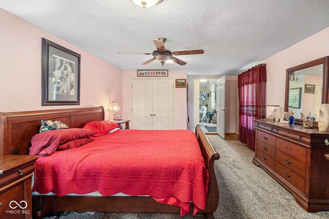 carpeted bedroom with a textured ceiling, a closet, and ceiling fan