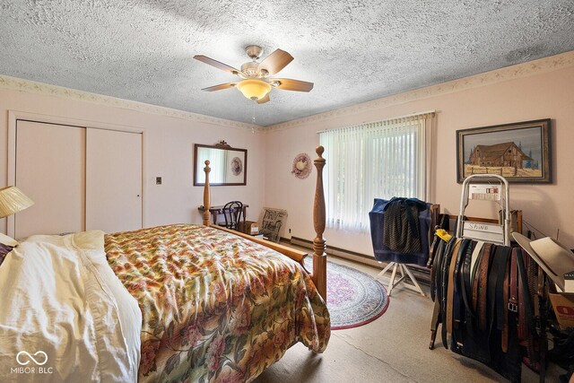 bedroom featuring a textured ceiling, a closet, carpet floors, and ceiling fan