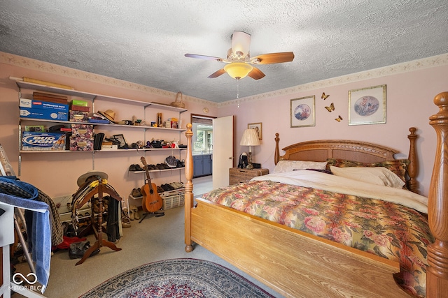 carpeted bedroom with a textured ceiling and ceiling fan