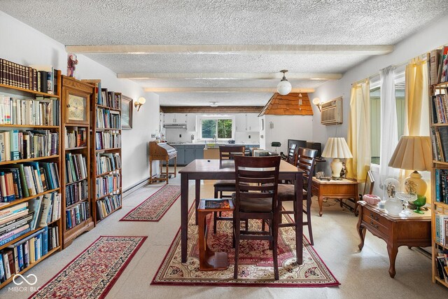 dining space with beamed ceiling, a wall unit AC, and a textured ceiling