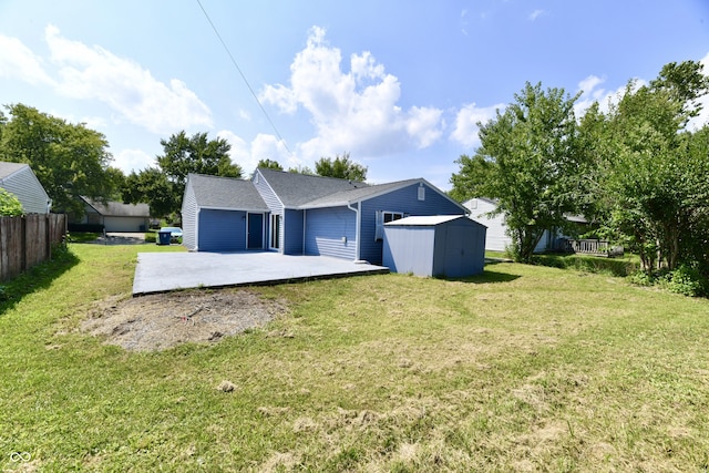 rear view of property with a lawn, a storage shed, and a patio