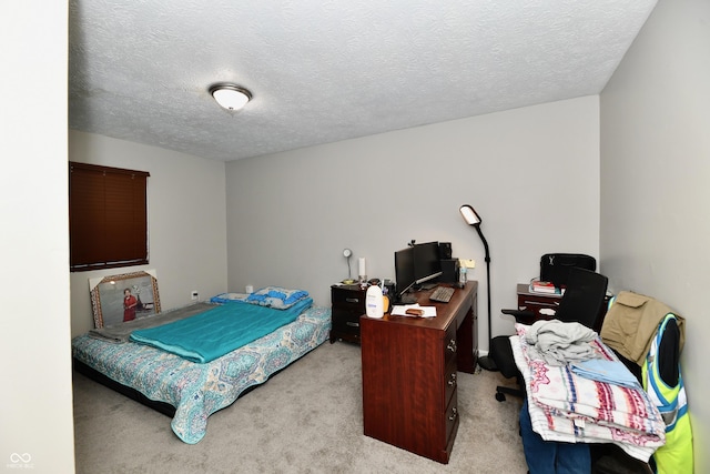 bedroom featuring light carpet and a textured ceiling