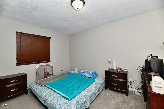 bedroom with a textured ceiling and light carpet