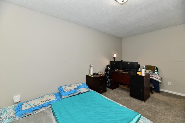 bedroom featuring a textured ceiling and light carpet