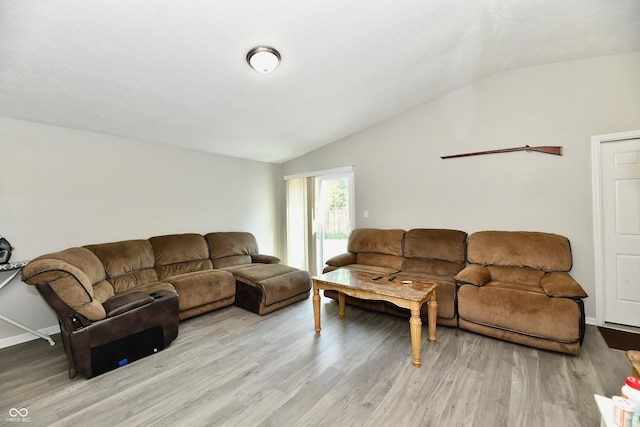 living room with baseboards, lofted ceiling, and light wood finished floors