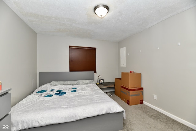 bedroom featuring a textured ceiling and carpet floors