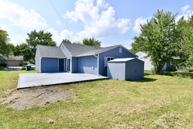 view of front of property featuring a front lawn, a patio area, and a storage shed