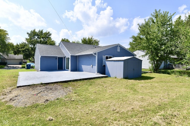 exterior space with an outbuilding, a patio area, a shed, a shingled roof, and a front yard