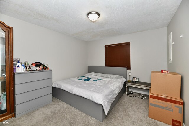 carpeted bedroom featuring a textured ceiling