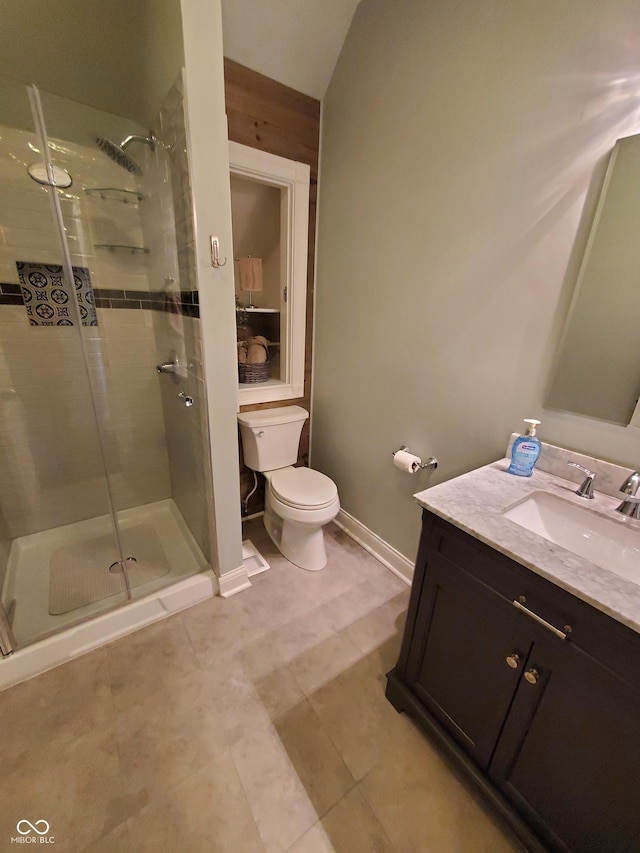 bathroom featuring vanity, an enclosed shower, and toilet