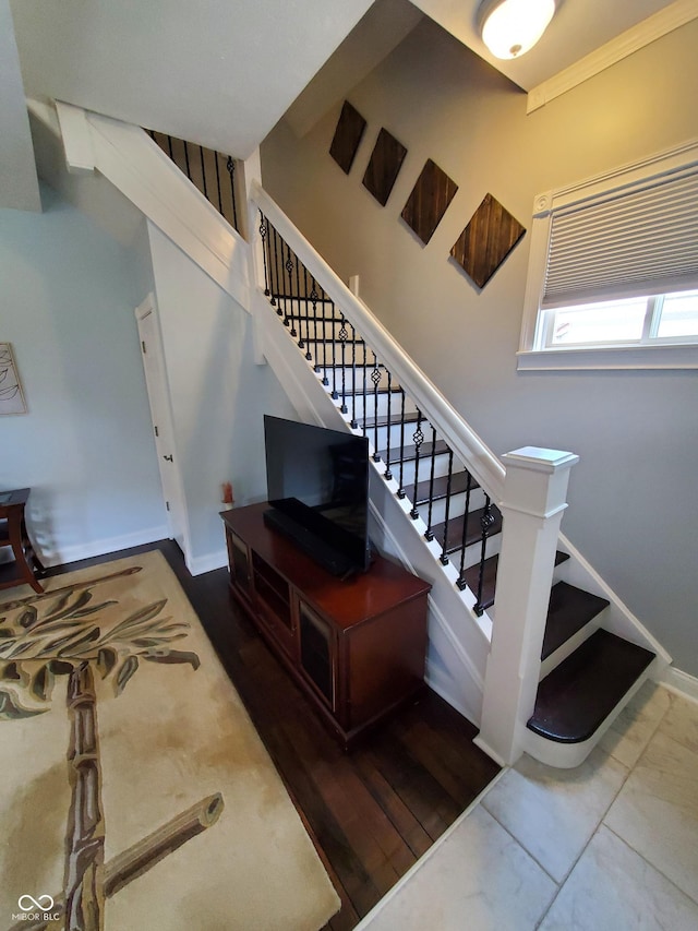 staircase with hardwood / wood-style floors