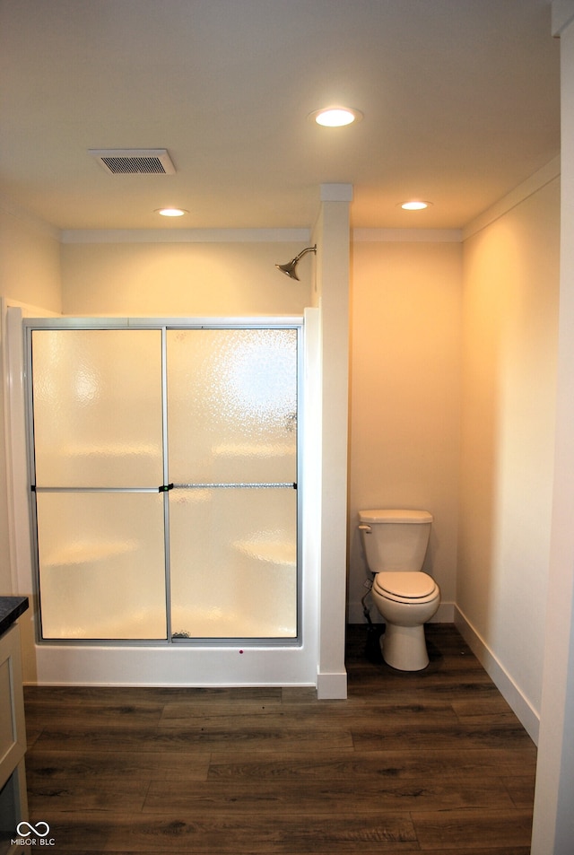 bathroom with hardwood / wood-style flooring, vanity, ornamental molding, and toilet