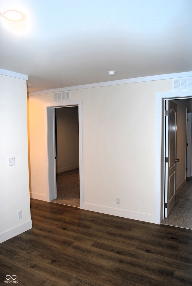 unfurnished room featuring dark hardwood / wood-style flooring