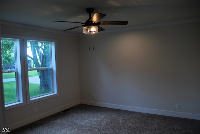 carpeted spare room with ceiling fan